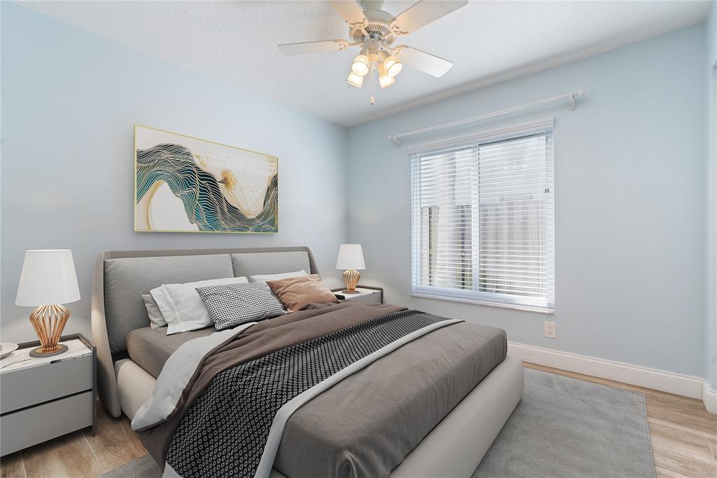 3240 Northwest 106th Avenue Sunrise, FL 33351 - Photo 14 of 21 a bedroom with a bed and a painting on the wall