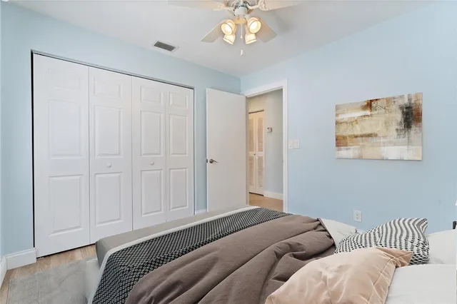 a bedroom with bed and a chandelier