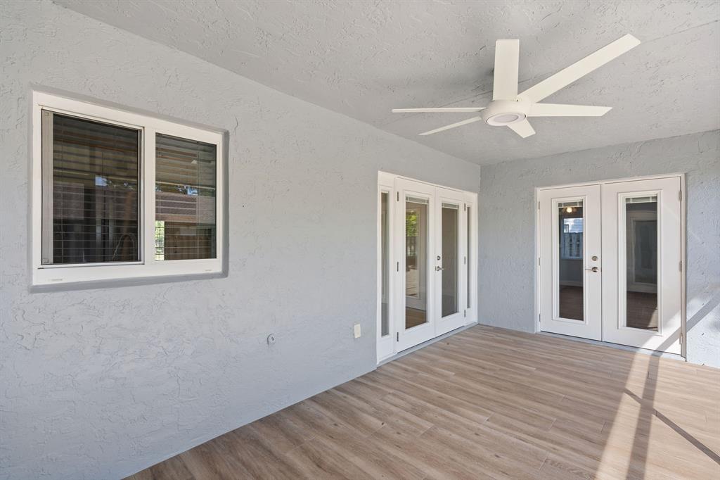 3240 Northwest 106th Avenue Sunrise, FL 33351 - Photo 17 of 21 a view of a room with wooden floor and a ceiling fan