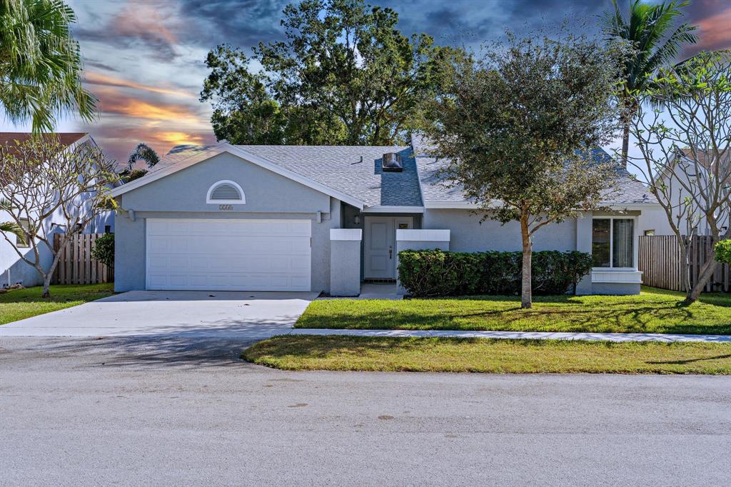 3240 Northwest 106th Avenue Sunrise, FL 33351 - Photo 2 of 21 a house with trees in the background