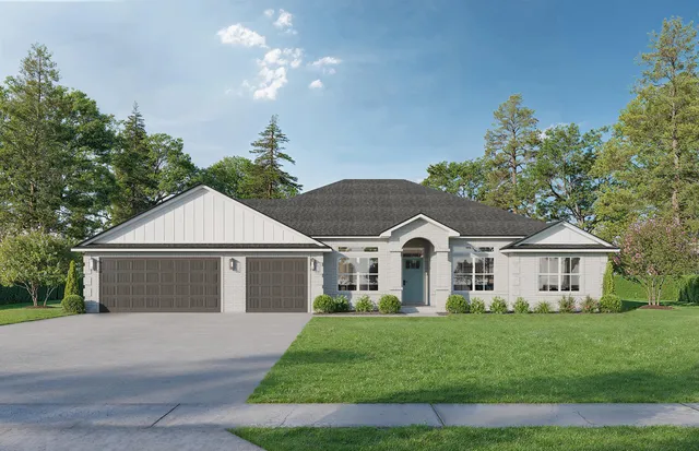 a view of a white house next to a yard with big trees