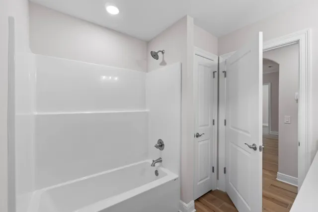 an empty room with closet and fan