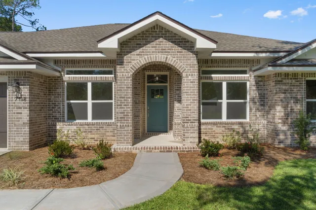 a kitchen with a sink a microwave and cabinets