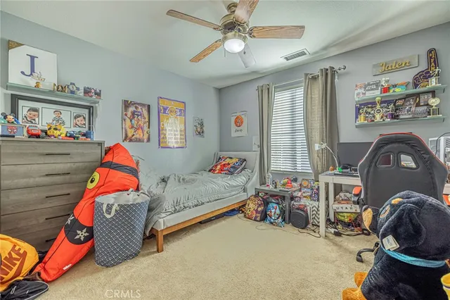a spacious bedroom with a bed a chandelier and closet