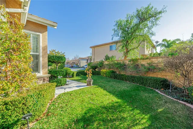 a view of backyard of house with green space