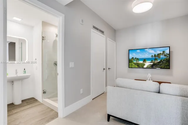a bathroom with a sink a mirror and a shower