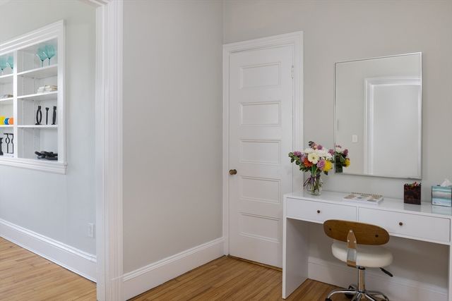 a dining room with furniture and wooden floor