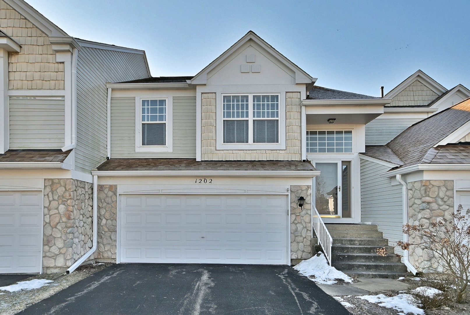 1202 Delta Drive Elgin, IL 60123 - Photo 1 of 23 a front view of a house with a garage