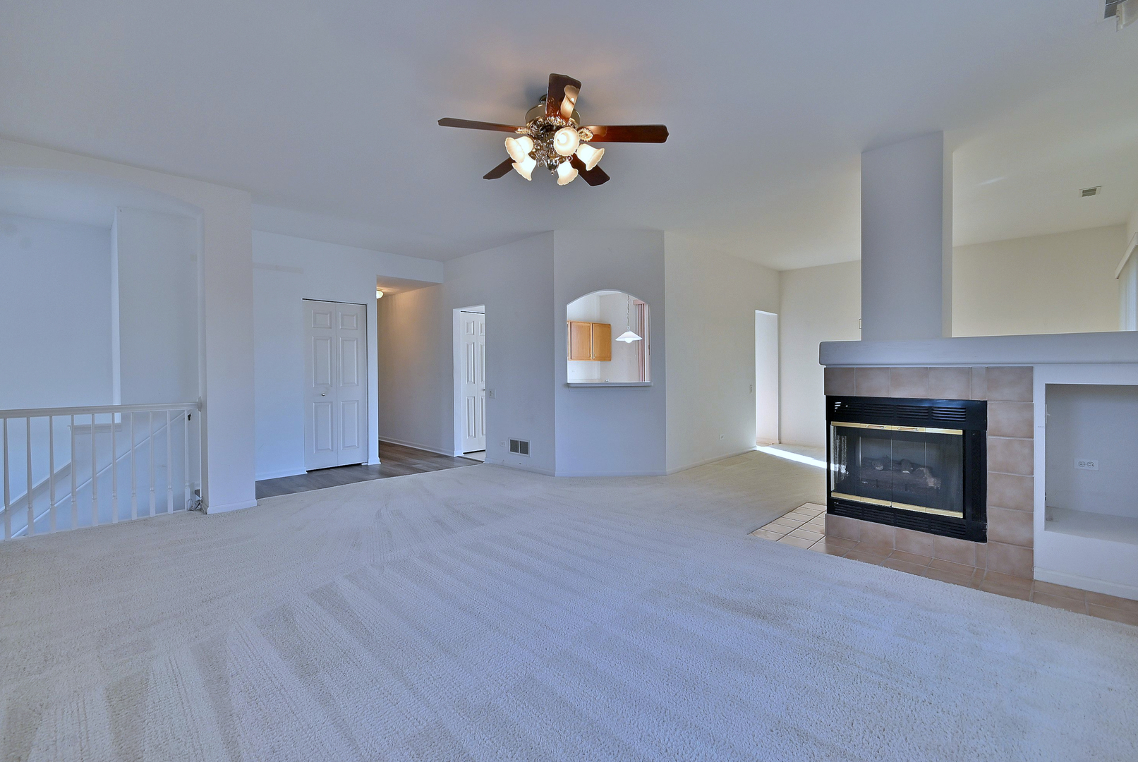 1202 Delta Drive Elgin, IL 60123 - Photo 11 of 23 a view of a livingroom with a fireplace a chandelier and windows