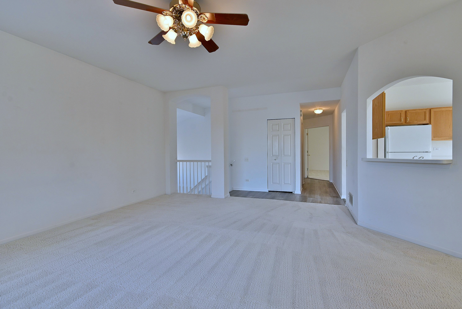 1202 Delta Drive Elgin, IL 60123 - Photo 12 of 23 a view of a room with a chandelier fan and wooden floor
