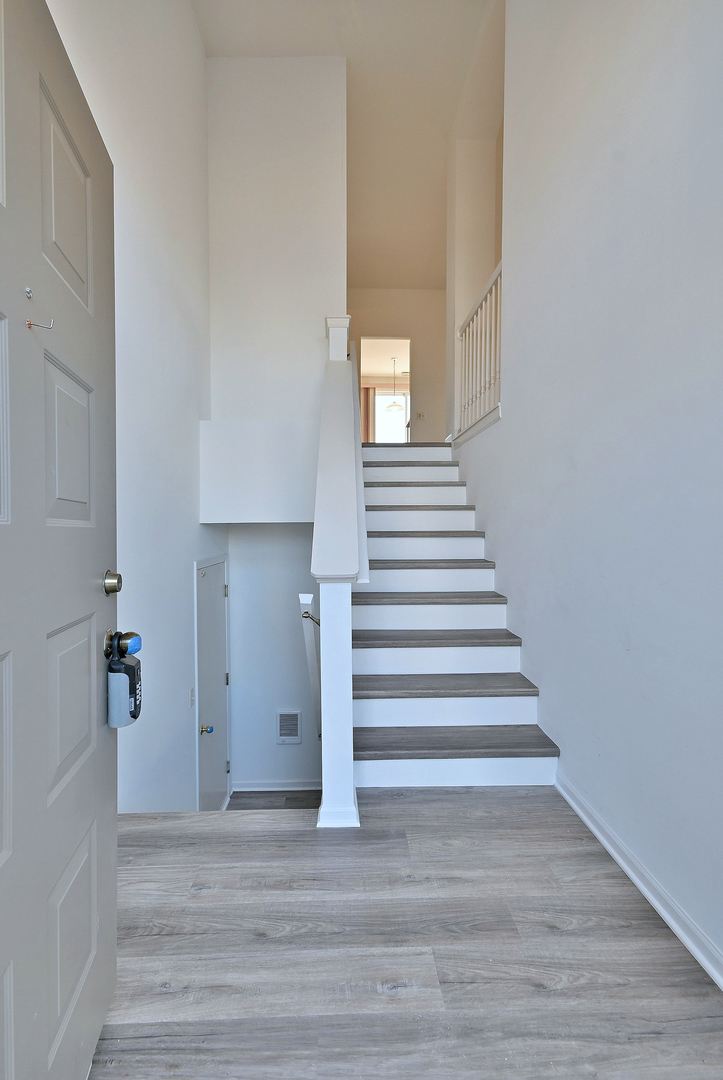 1202 Delta Drive Elgin, IL 60123 - Photo 2 of 23 a view of entryway and hall with wooden floor