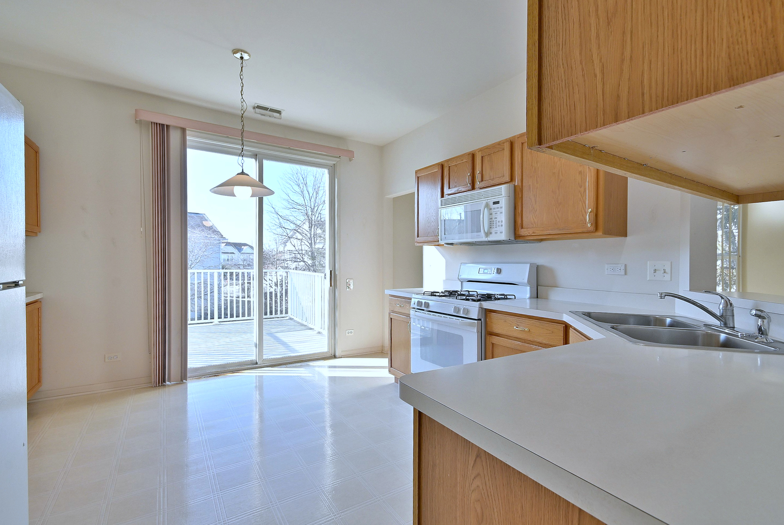 1202 Delta Drive Elgin, IL 60123 - Photo 3 of 23 a kitchen with stainless steel appliances granite countertop a sink a stove and a wooden floors