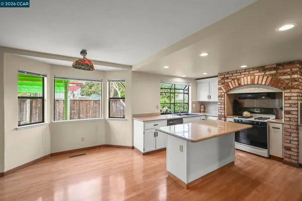 a kitchen with a stove a sink and a microwave
