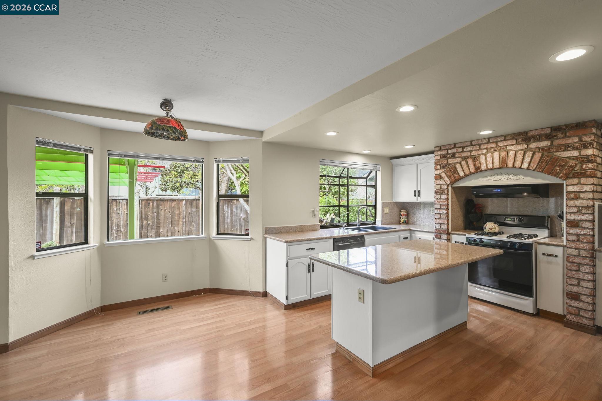 5017 Murchio Drive Concord, CA 94521 - Photo 11 of 30 a kitchen with a stove a sink and a microwave