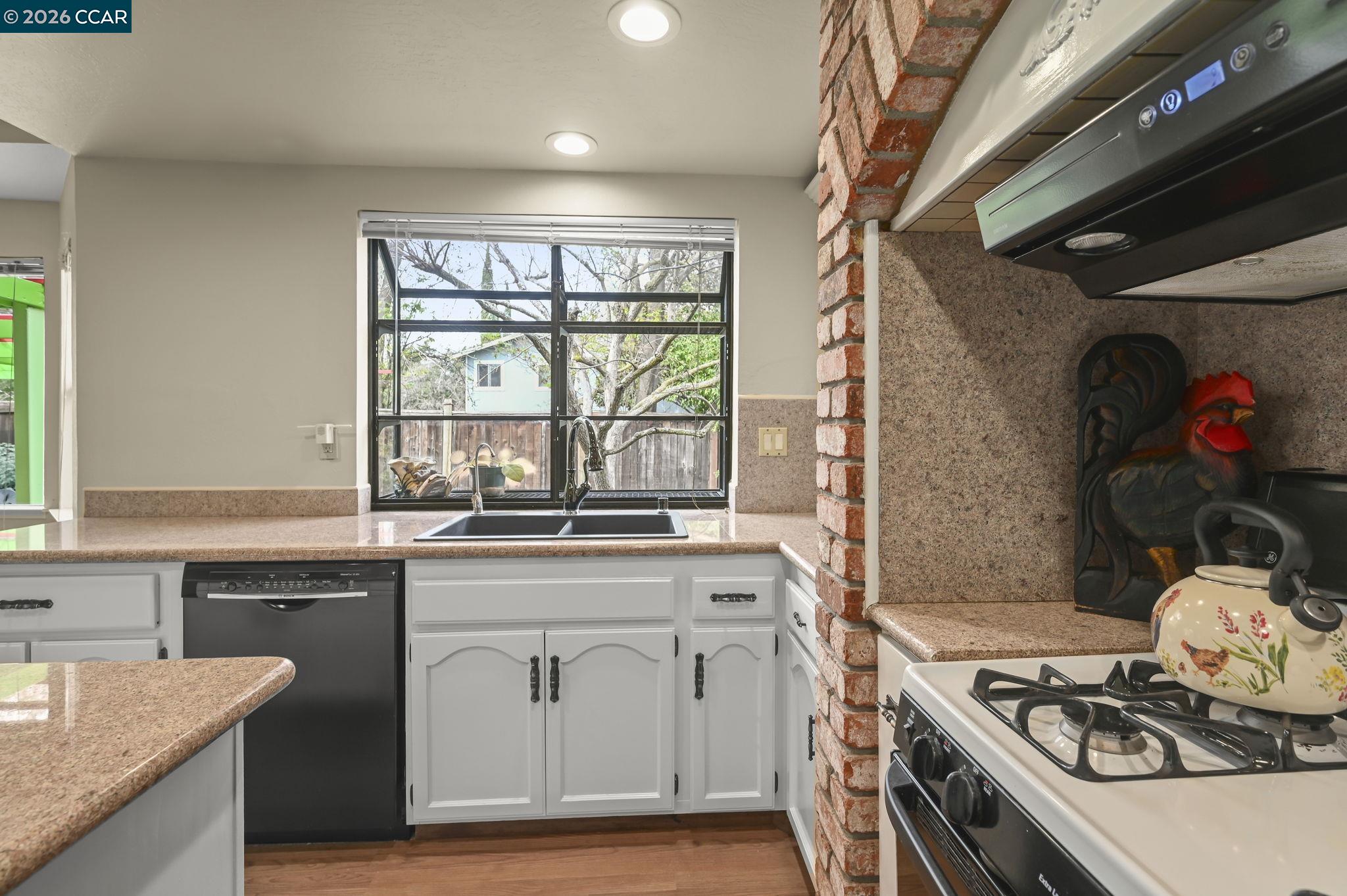 5017 Murchio Drive Concord, CA 94521 - Photo 12 of 30 a kitchen with a stove a sink and cabinets