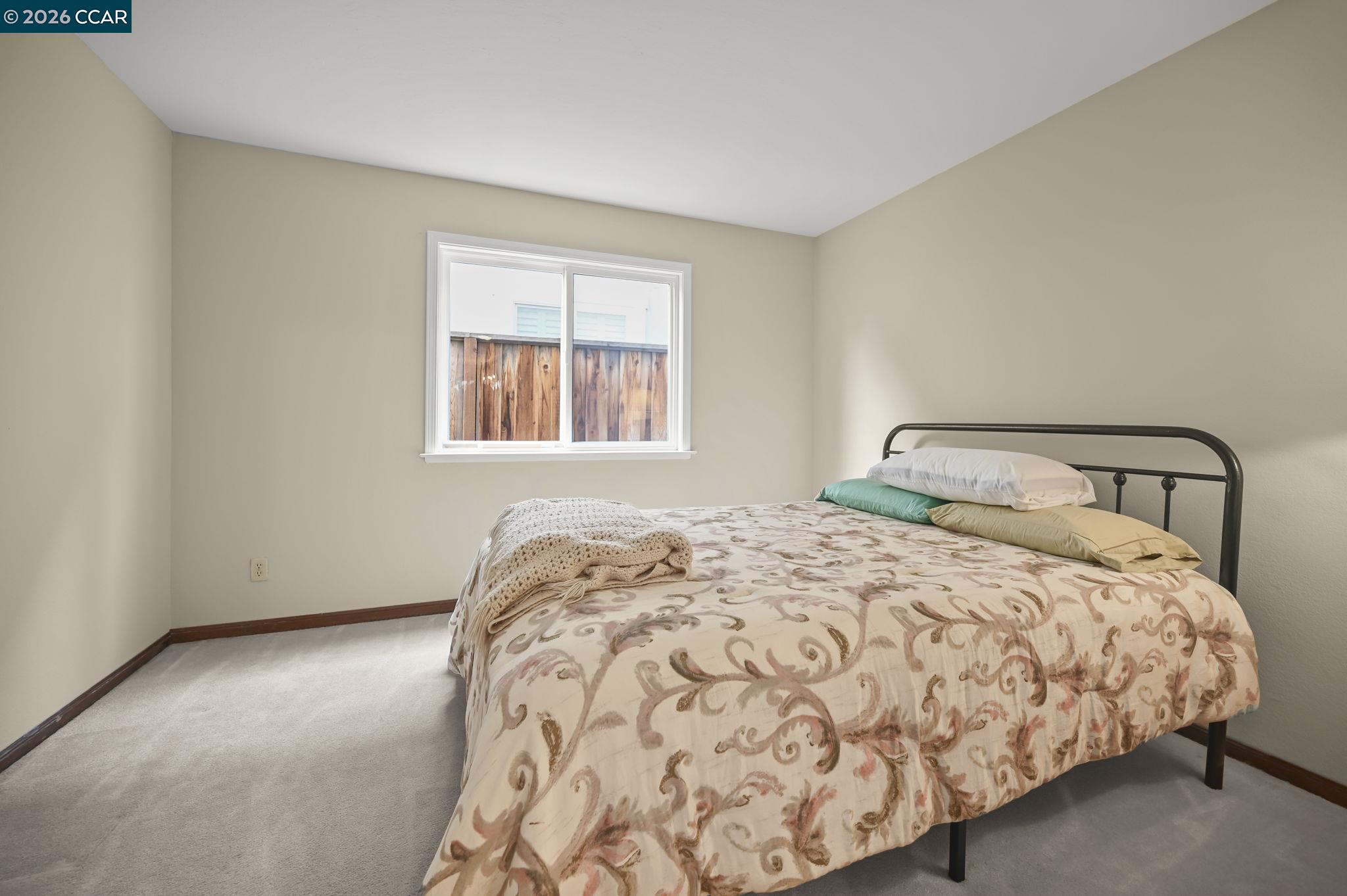 5017 Murchio Drive Concord, CA 94521 - Photo 15 of 30 a bedroom with a bed and window