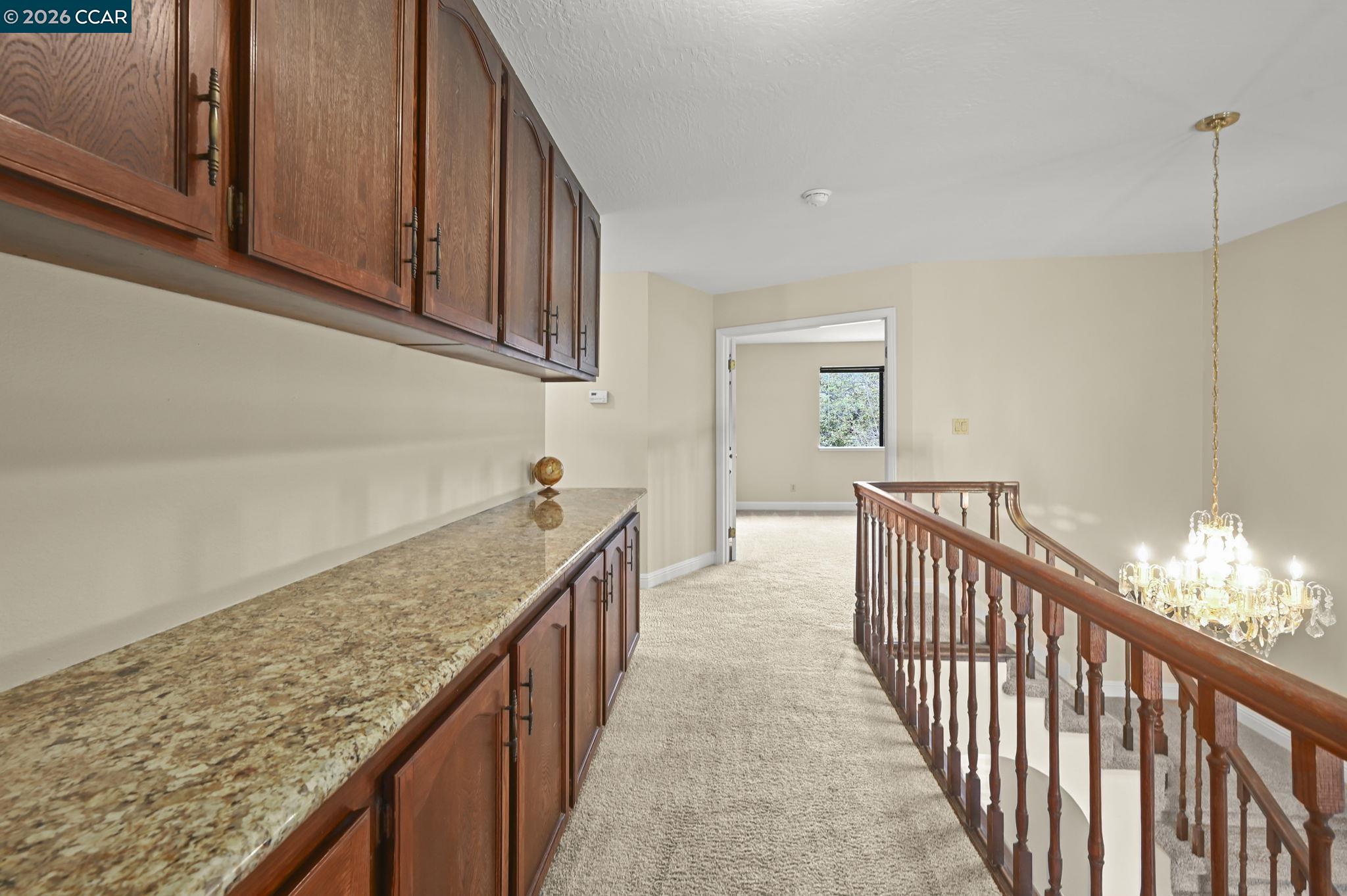 5017 Murchio Drive Concord, CA 94521 - Photo 16 of 30 a view of a hallway with wooden floor and staircase