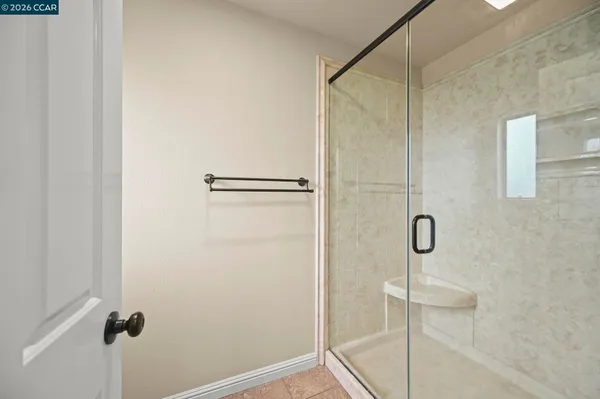 a bathroom with a glass shower door