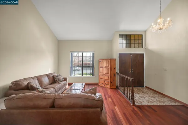 a living room with furniture and a chandelier