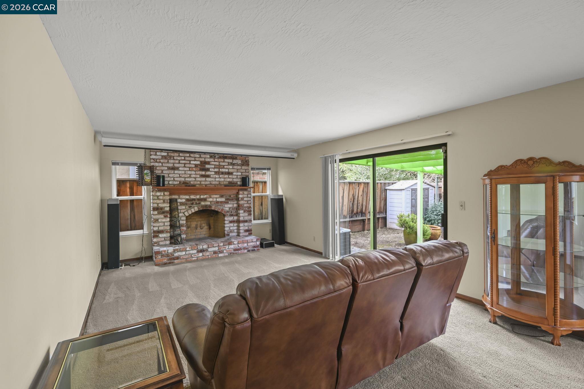 5017 Murchio Drive Concord, CA 94521 - Photo 8 of 30 a living room with furniture a floor to ceiling window and a fireplace