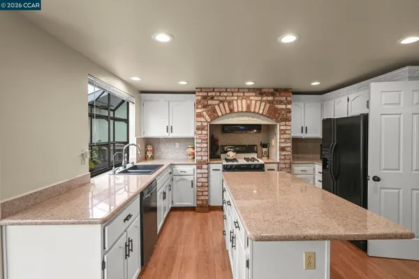 a kitchen with a stove a refrigerator and a sink
