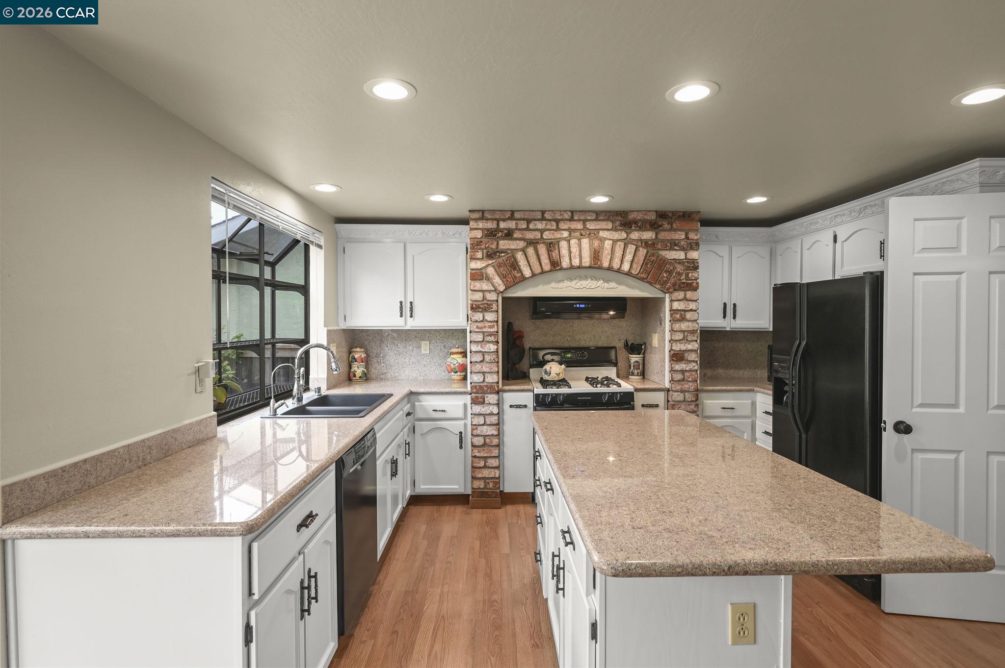 5017 Murchio Drive Concord, CA 94521 - Photo 10 of 30 a kitchen with a stove a refrigerator and a sink