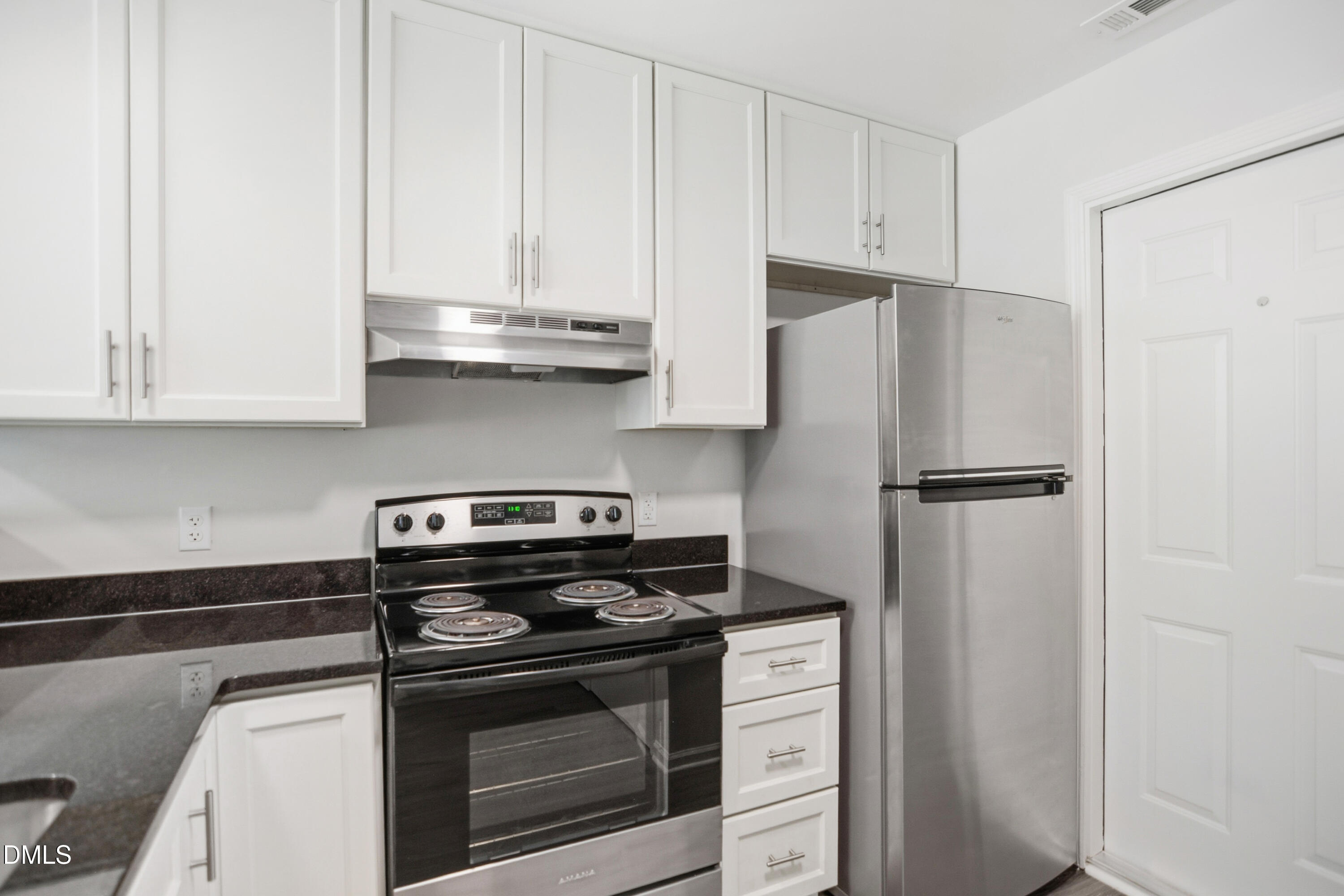 1931 Tischer Road Raleigh, NC 27603 - Photo 11 of 19 a kitchen with stainless steel appliances granite countertop white cabinets and a stove