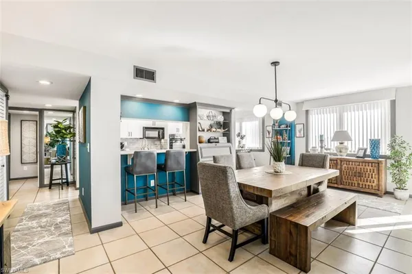 a living room with furniture and kitchen view