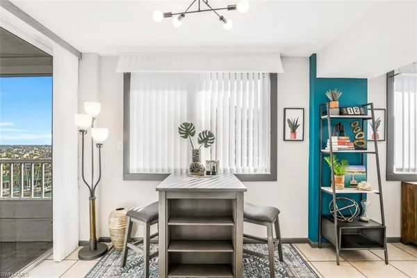 a living room with furniture and a book shelf