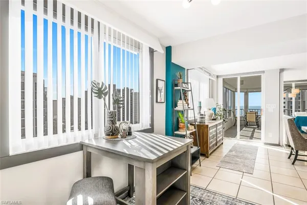 a view of a kitchen with granite countertop a dining table and chairs