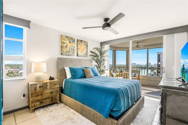 a bedroom with a large bed and a large window