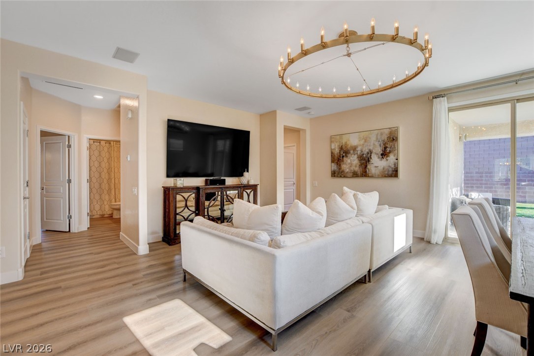 2649 Rue Marquette Avenue Henderson, NV 89044 - Photo 10 of 55 This generous living space features resilient flooring, an impressive chandelier, and direct patio access.