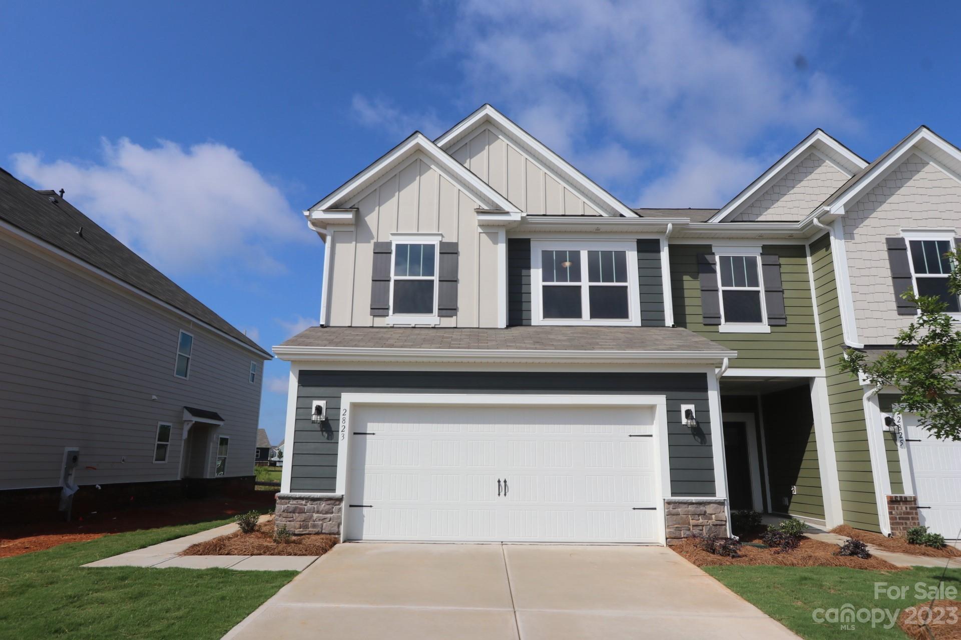a view of a white house with a yard