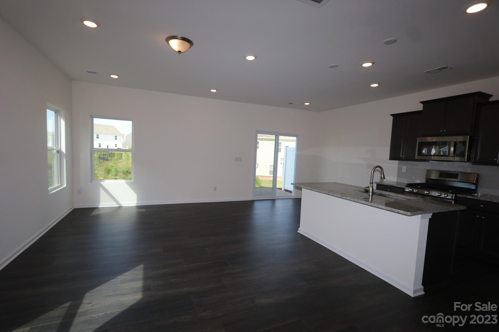 2823 Trinity Street Monroe, NC 28110 - Photo 2 of 5 a kitchen with stainless steel appliances a sink dishwasher a stove and a refrigerator