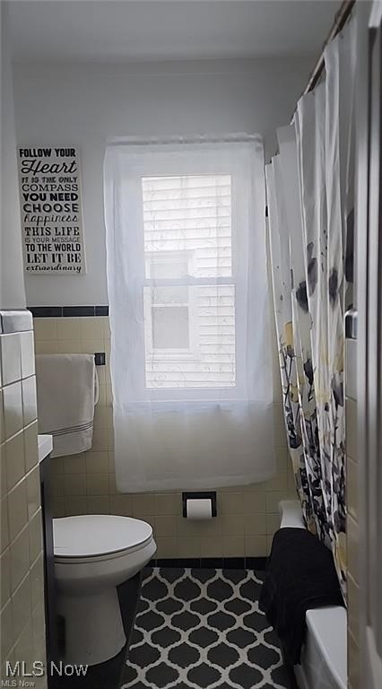 23621 Colbourne Road Euclid, OH 44123 - Photo 25 of 45 Bathroom featuring tile patterned flooring, shower / tub combo, tile walls, and toilet