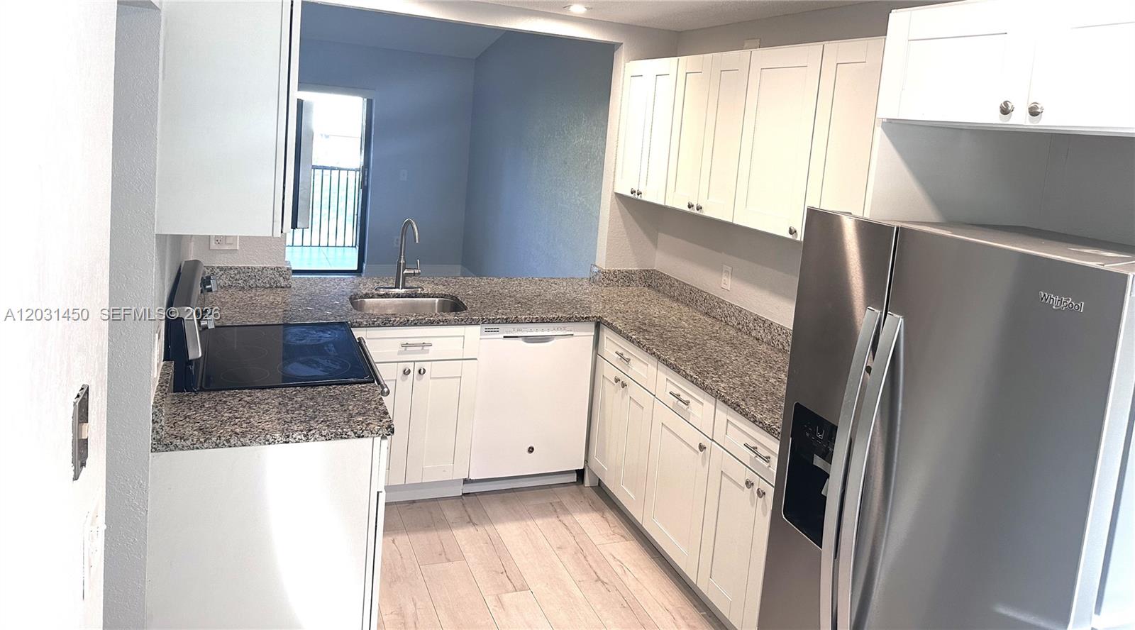 23398 Lyons Road, Unit 309 Boca Raton, FL 33428 - Photo 12 of 16 a kitchen with a sink a counter top space and cabinets