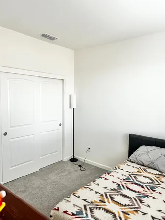 a bedroom with a bed and a cabinet