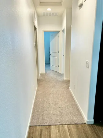 view of a hallway with wooden floor and closet