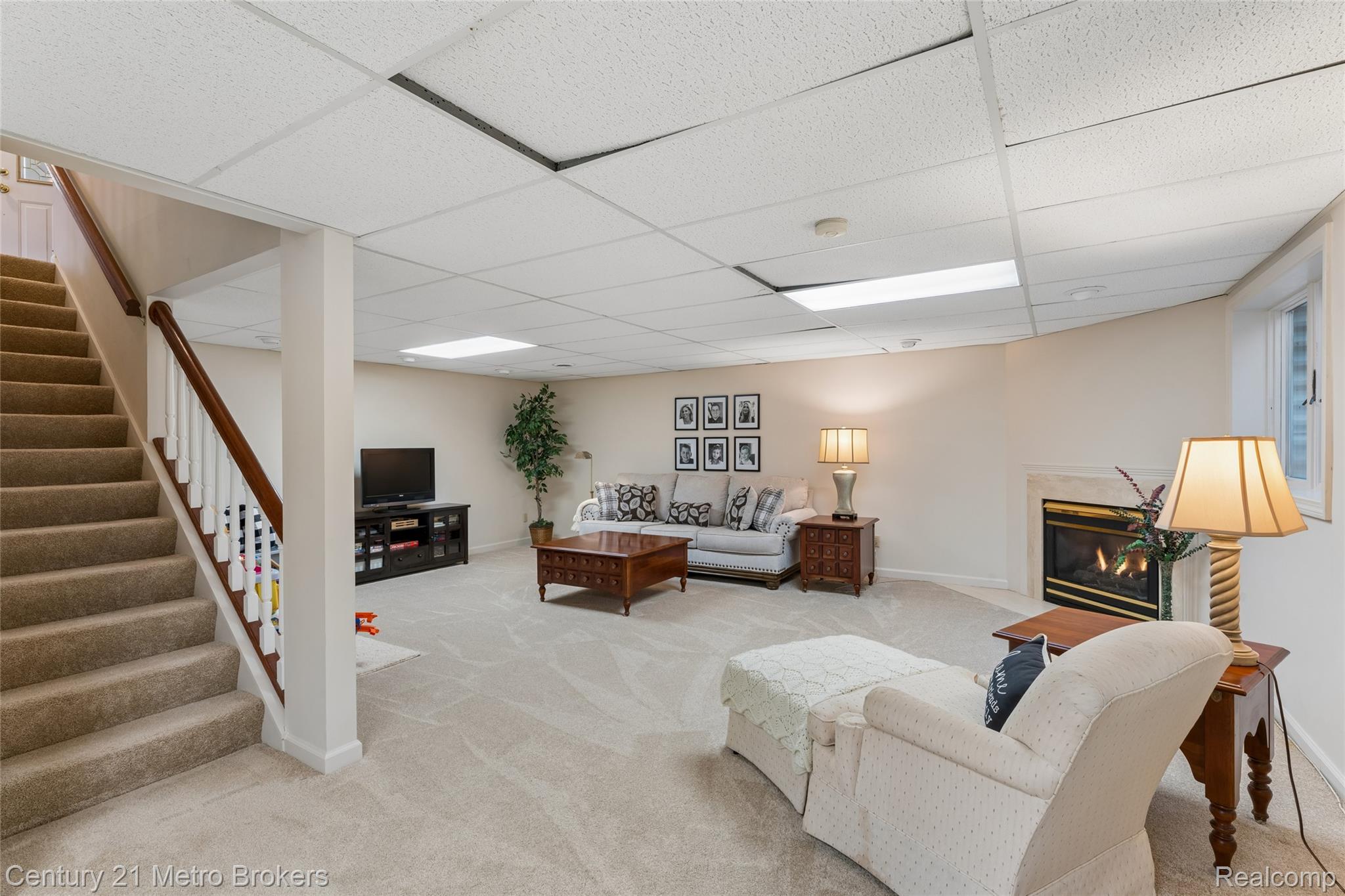 5464 North Seymour Road Flushing, MI 48433 - Photo 37 of 59 Lower level family area with light colored carpet, and a fireplace