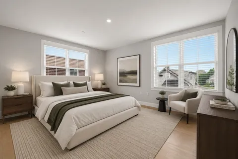 a bedroom with double bed and a large window