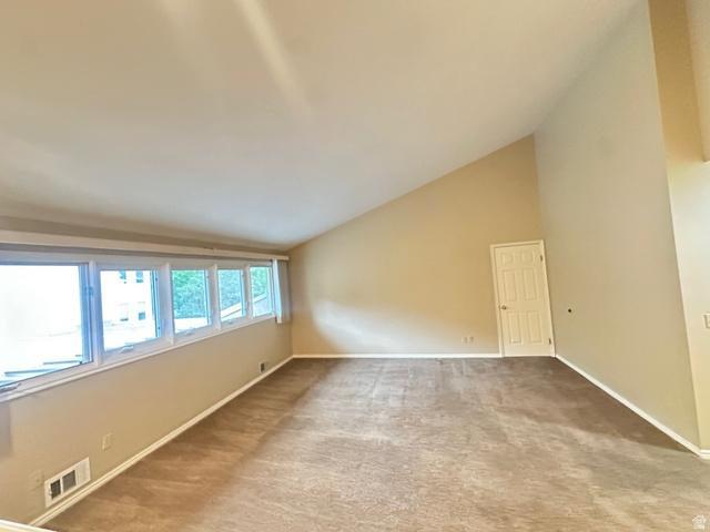 1715 Darling Street, Unit 3 Ogden, UT 84403 - Photo 16 of 26 Spacious room featuring vaulted ceilings and natural light from large windows