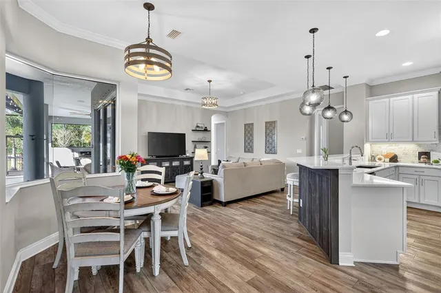 a large kitchen with a table and chairs