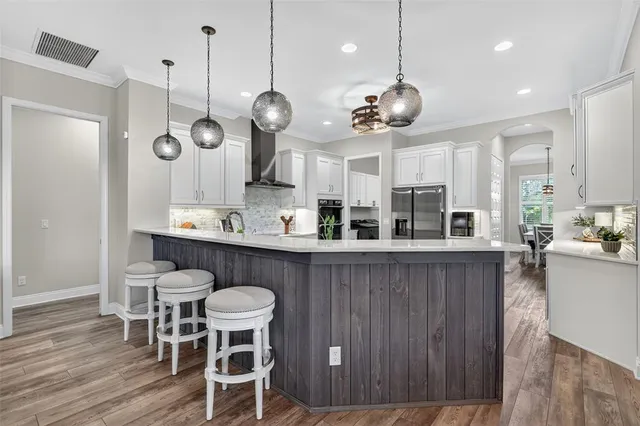 a bathroom with a granite countertop sink a toilet and mirror
