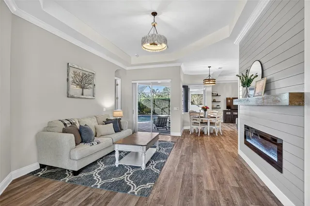 a living room with furniture a fireplace and a table