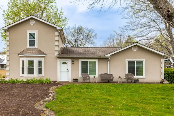 a living room with furniture and a ceiling fan