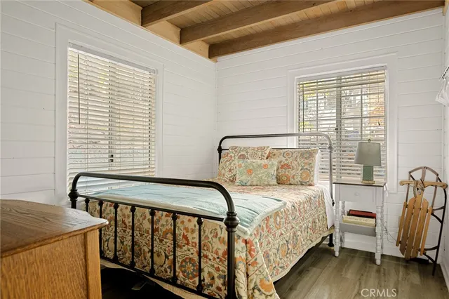 a bedroom with a bed and a mirror