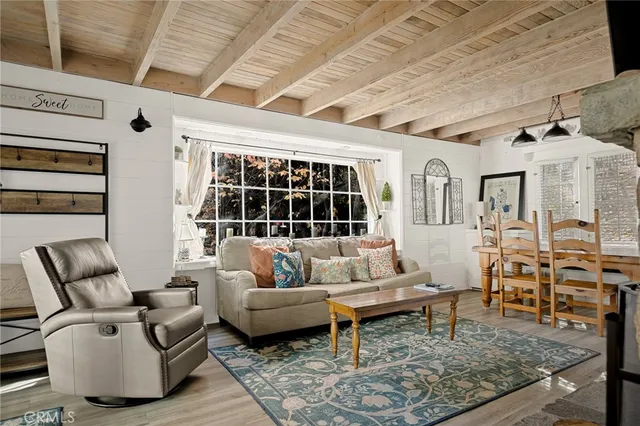 a living room with furniture wooden floor and a table