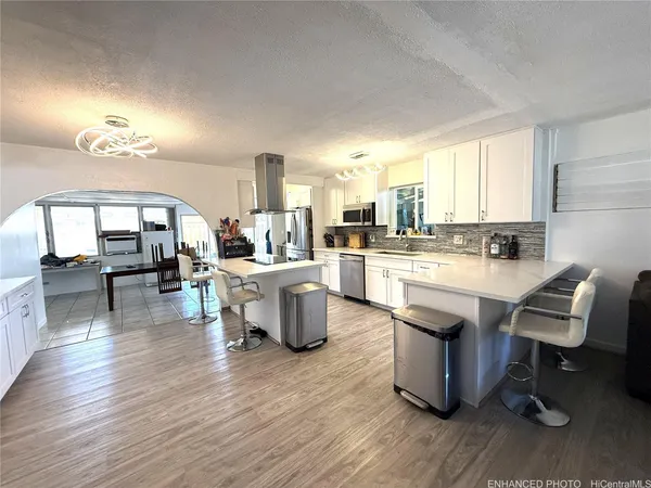 a large kitchen with a table and chairs