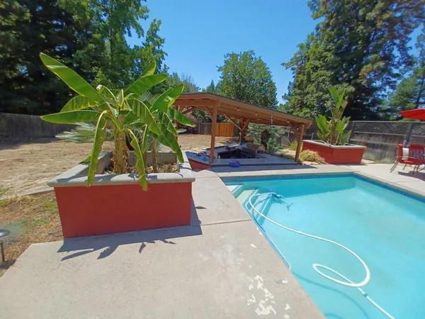 a white house that has a tree in front of it