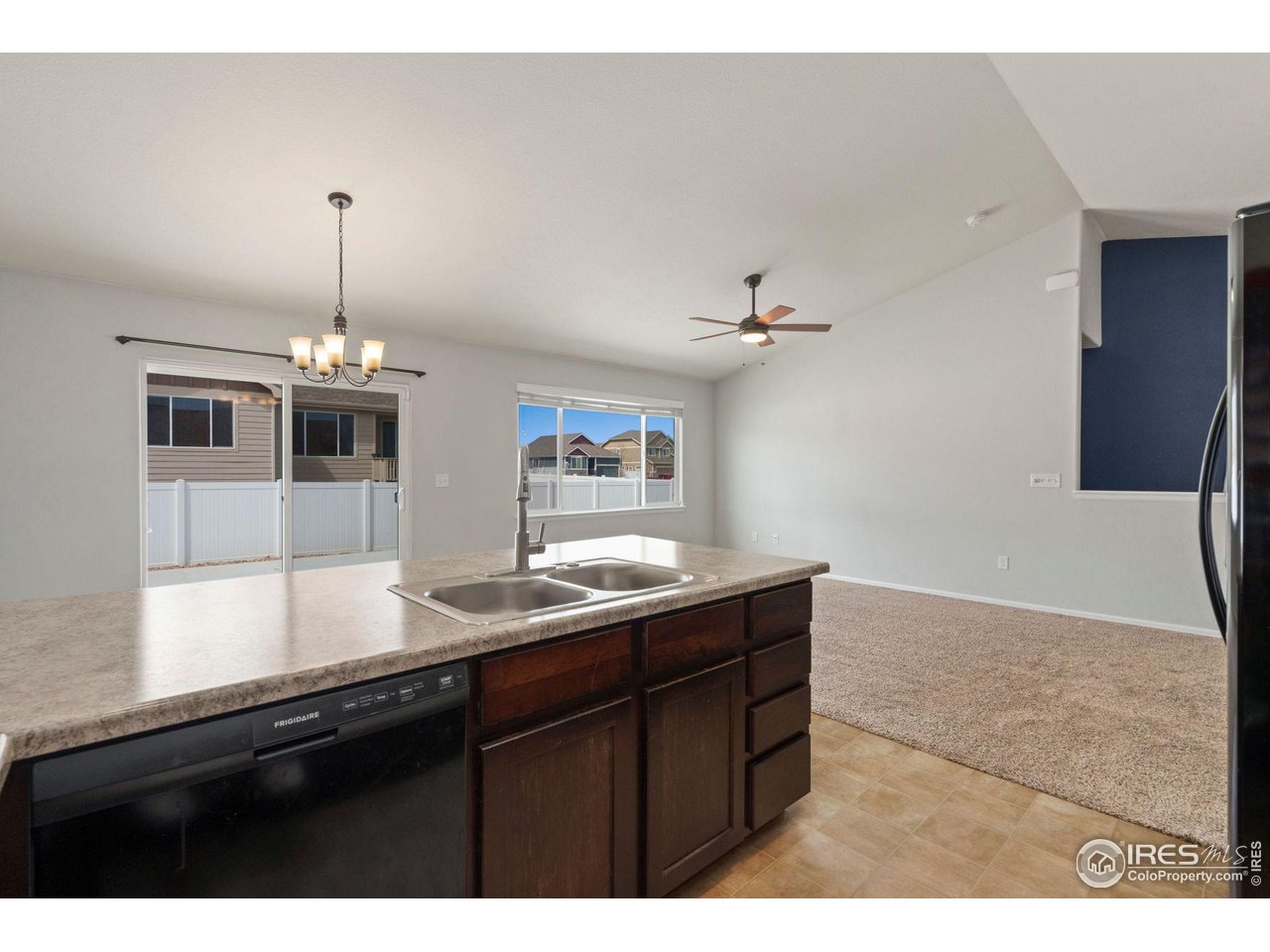 856 Sunlight Peak Drive Severance, CO 80550 - Photo 15 of 40 a kitchen with a sink and chandelier